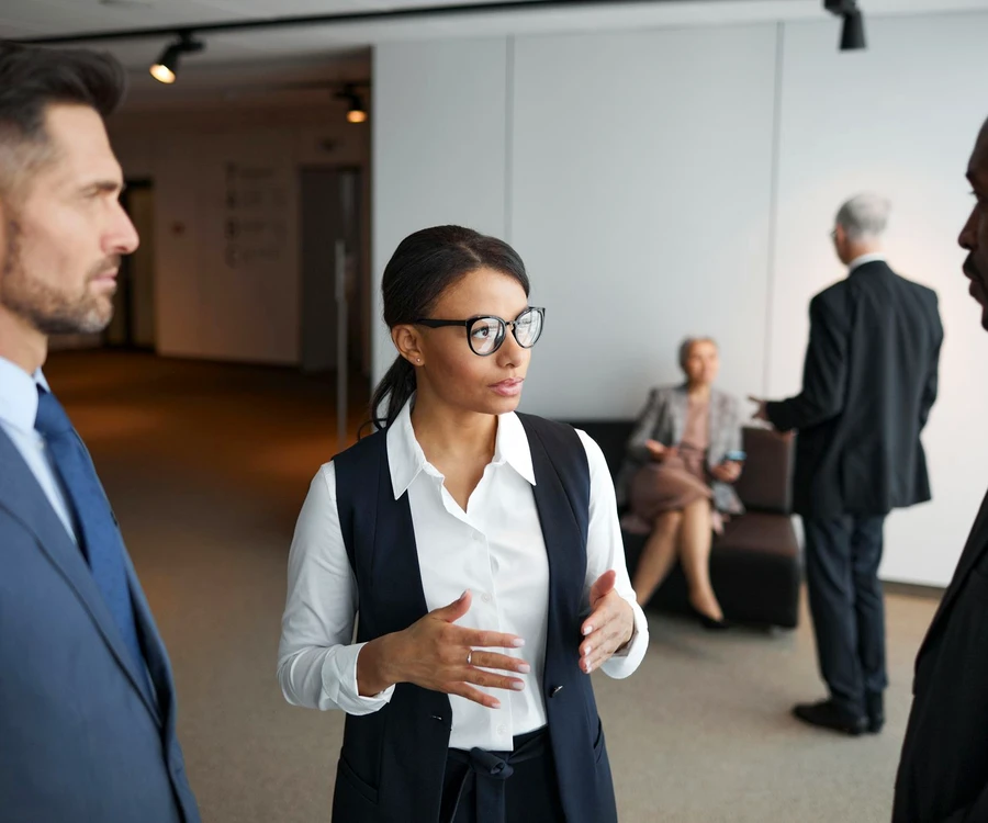 A woman leading a conversation with colleagues in an office